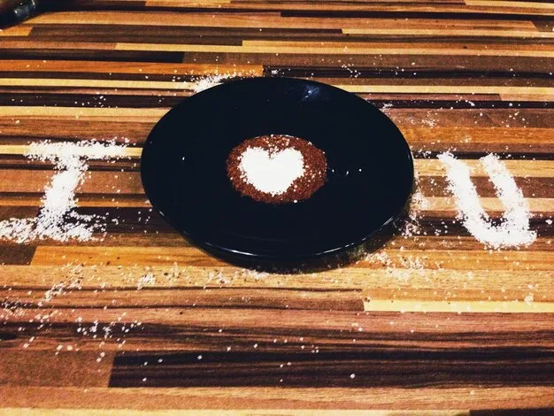 A vintage vinyl record of Leonard Cohen's 'Songs of Love and Hate' album, with a slightly worn and textured surface. The album cover should be visible, conveying the melancholic atmosphere of the music that complements the film. The image represents the emotional depth added to McCabe & Mrs. Miller (1971) through its soundtrack.