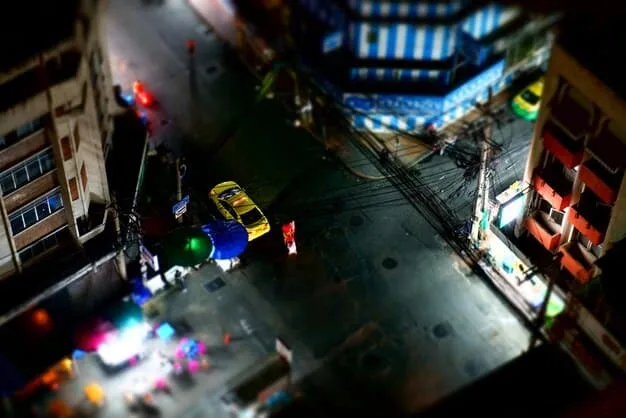 A wide shot depicting the chaotic street scene in 'They Live' after the television signal revealing the aliens is broadcast. People are rioting, confronting the aliens openly, and destroying billboards displaying the subliminal messages. The scene embodies the film's message of resistance against manipulation.