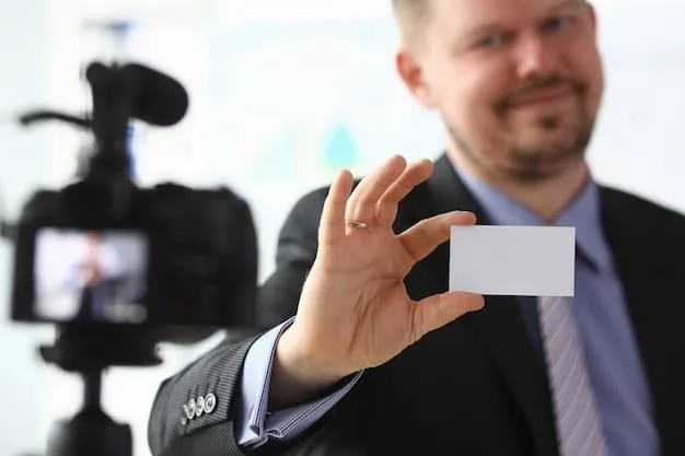 A close-up shot of a filmmaker exchanging business cards with a potential investor at a film festival, showcasing a key aspect of networking in the film industry.