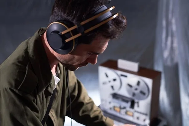 A filmmaker wearing headphones, intently focused on monitoring audio levels during a short film shoot. The background includes film equipment and crew members, capturing the atmosphere of a professional film set.