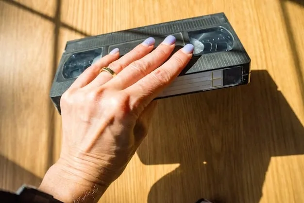 A close-up shot of a person's hand inserting a VHS tape into a VCR, with a shelf full of various VHS tapes in the background. The scene should be dimly lit, creating a nostalgic and slightly grainy atmosphere reminiscent of the VHS era.