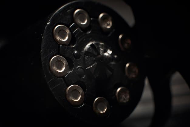 A close-up shot of a film reel threading through a vintage projector, with a slightly blurred background of a darkened cinema. The focus is on the intricate mechanics and textural details of the film and projector.