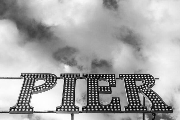 A black and white photo of a vintage movie theater marquee, with the words 