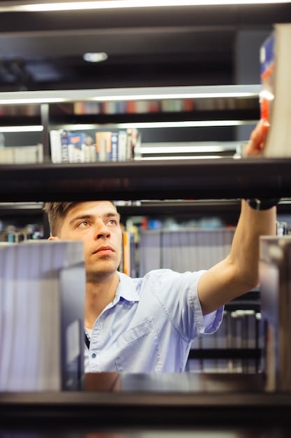 A dimly lit independent video store with shelves overflowing with VHS tapes. Two people are browsing the shelves, one holding up a particularly obscure-looking tape.