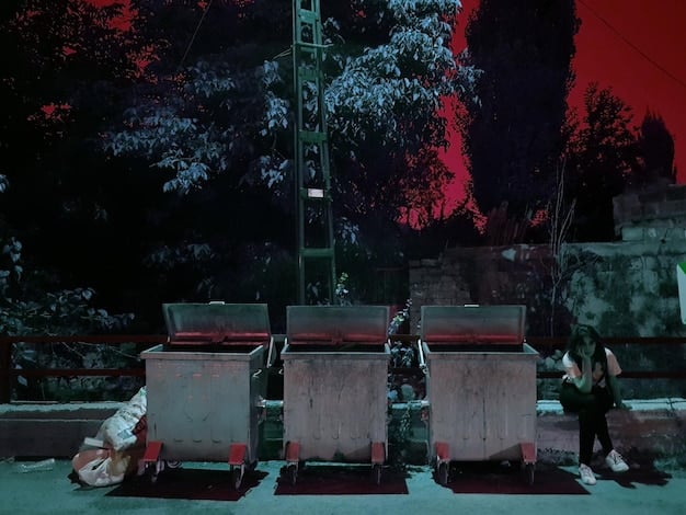 A stylized image of a film clapperboard with blood splatters, placed in front of a graveyard scene at twilight. Ghostly figures lurk in the background.