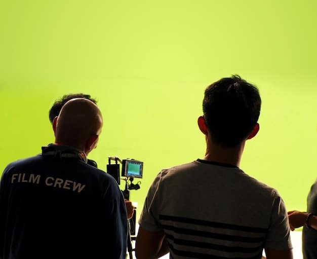 A behind-the-scenes shot of an indie film crew using natural light and minimal equipment to film a scene. The focus is on the resourcefulness and improvisational techniques used to overcome budget limitations.