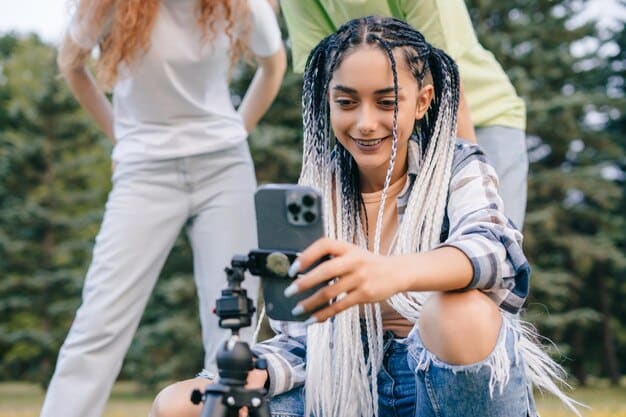 A diverse group of young filmmakers on a location shoot, using a smartphone camera and minimal equipment, highlighting accessibility and inclusivity in filmmaking.