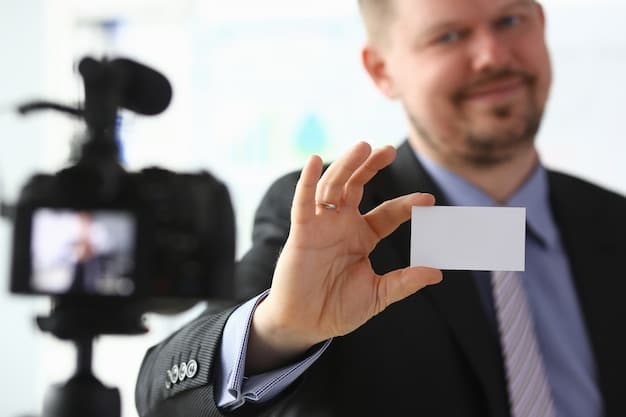 A close-up shot of a filmmaker exchanging business cards with a potential investor at a film festival, showcasing a key aspect of networking in the film industry.