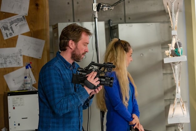 A film director and cinematographer collaborating on set, reviewing footage and discussing technical aspects of the film, highlighting the importance of teamwork in filmmaking.