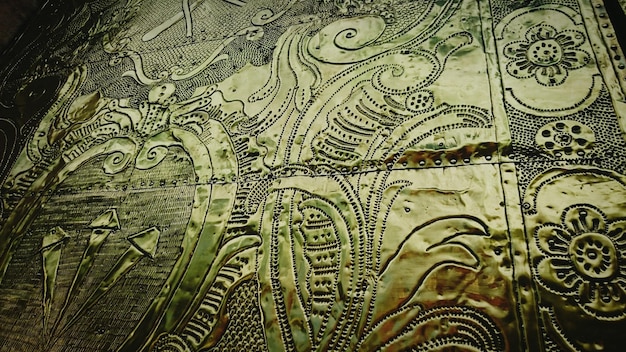 A close-up photograph of a weathered, medieval manuscript, revealing intricate calligraphy and detailed illustrations. The manuscript is open to a page depicting a vibrant scene from a historical event, showcasing the artistry and craftsmanship of the era.