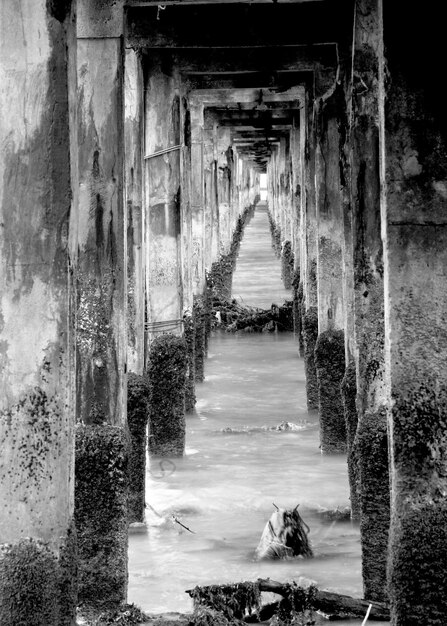 A black and white photo depicting a neglected artwork stored in a dusty museum archive, symbolizing the impact of cultural neglect on art history.
