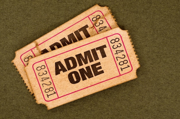 A close-up of a movie ticket stub with the title of an international film visible, along with dollar bills, symbolizing the financial stakes in the US market.