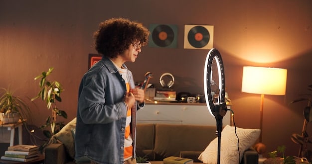 A person in a home studio recording foley sounds. They are using various props such as shoes, fabric, and a small container of water to create footsteps, cloth rustling, and liquid sounds. A microphone is positioned close to the props to capture the sounds clearly, illustrating budget Short Film Sound Design: Creating Immersive Audio Experiences on a Limited Budget.