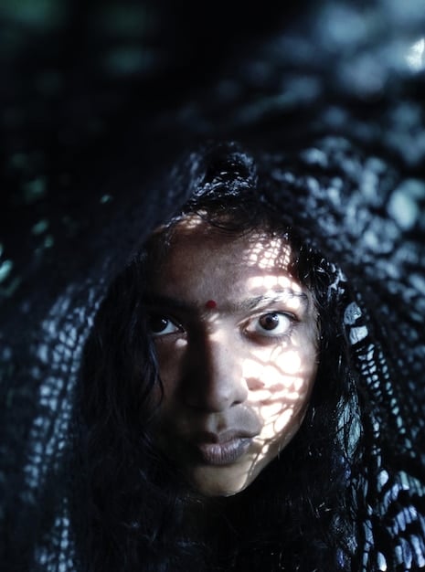 A close-up shot of one of the main characters in 'Dawn of the Dead' looking distressed and conflicted, holding a weapon. The expression on their face captures the internal struggle between maintaining their humanity and the necessity of violence for survival, a central theme related to Beyond the Gore: The Social Commentary of 'Dawn of the Dead' (1978) and its Relevance Today.