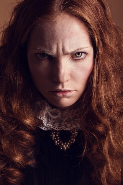 A close-up shot of Julie Christie as Constance Miller, with a determined expression on her face. She is sitting at a table in the saloon, counting money. The lighting is dim and smoky, highlighting her sharp features and conveying her intelligence and resourcefulness. The scene captures the essence of McCabe & Mrs. Miller (1971) and its slow-burn narrative.