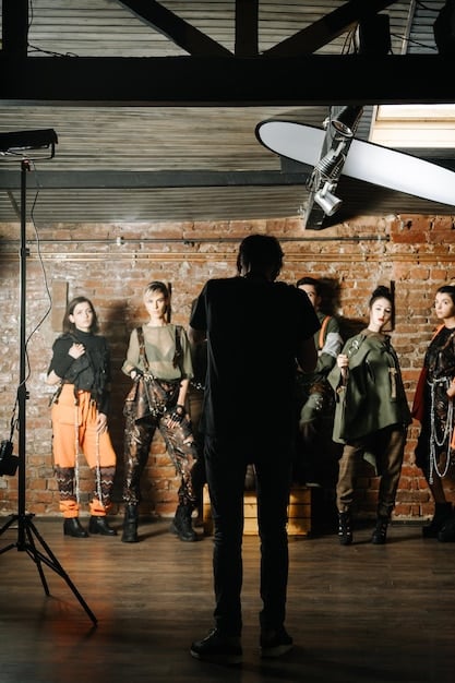 A behind-the-scenes photo showing a film crew during the French New Wave era, with the director (possibly Alain Resnais or Louis Malle) giving instructions to the actors. The image captures the collaborative and spontaneous spirit of filmmaking characteristic of Beyond the Blockbuster: Discovering Hidden Gems in French New Wave Cinema.