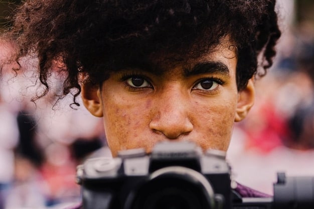 A close-up shot of a young filmmaker looking through the camera lens, their expression a mix of determination and passion. The background is blurred, showing a film set in motion. This image embodies the energy and dedication of the new wave of Eastern European directors.