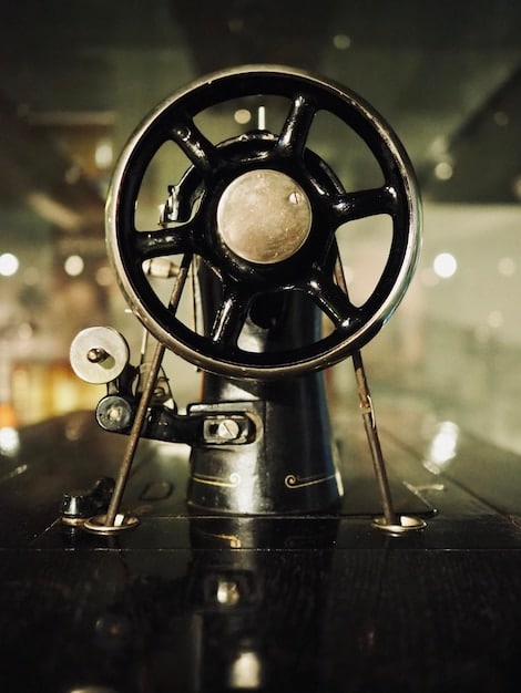 A vintage movie projector standing next to a modern high-resolution monitor displaying restored film footage, symbolizing the blend of old and new technologies in film preservation.