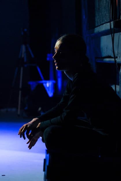 Will Graham (William Petersen) intensely studying crime scene photos, with neon lighting casting shadows across his face, conveying a sense of deep concentration and the psychological weight of the investigation. The image captures the film's stylish thriller aesthetic and is relatable to Unearthing Hidden Gems: 5 Overlooked Cult Classics from the 1980s You Need to See Before 2025.