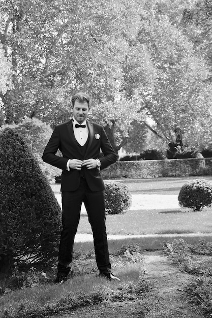 A black and white still photograph of Harold (Bud Cort) attending a funeral in 